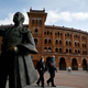 An elderly couple walks by Las Ventas in Madrid.